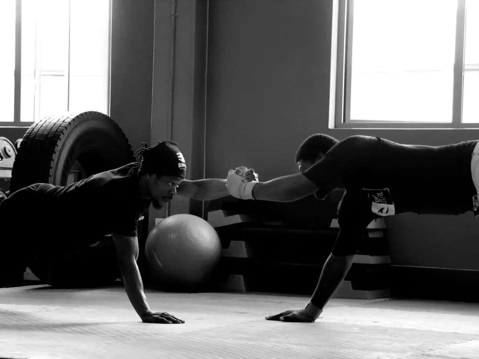 Coach and student working through floor conditioning at Iron Fists Academy